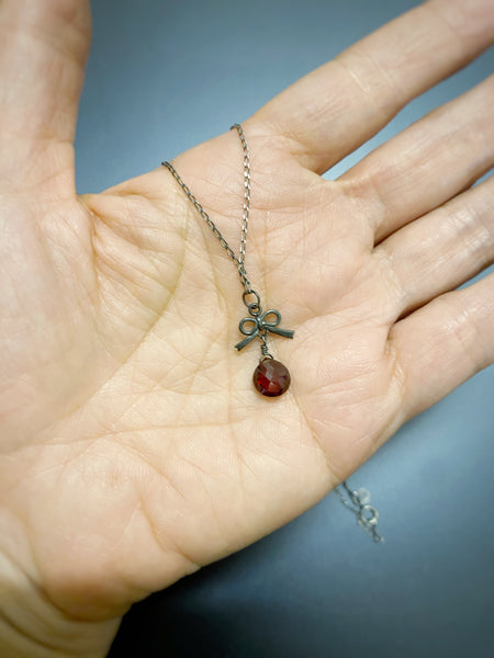 Tiny bow and garnet necklace