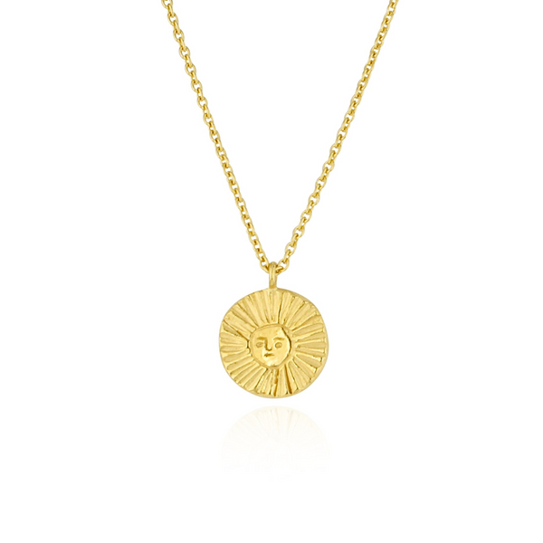 Gold necklace with a sun-shaped pendant on a white background
