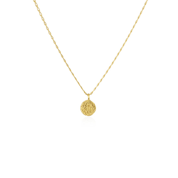 Gold necklace with a round pendant on a white background