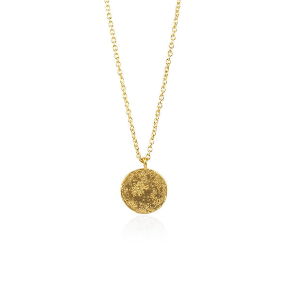 Gold necklace with a round pendant on a white background