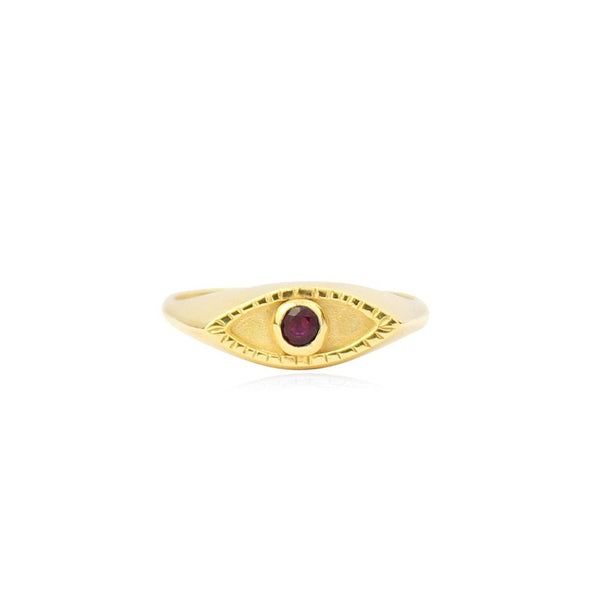 Gold ring with a red gemstone on a white background