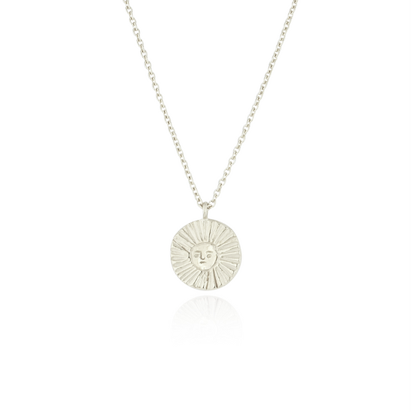 Silver necklace with a sun pendant on a white background