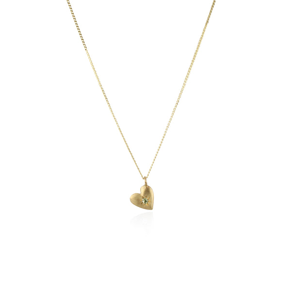 A gold necklace featuring a double heart charm with a peridot  birthstone, attached to a diamond cut curved  chain.