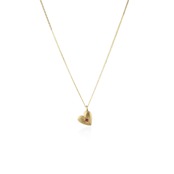 A gold necklace featuring a double heart charm with a ruby birthstone, attached to a diamond cut curved chain.