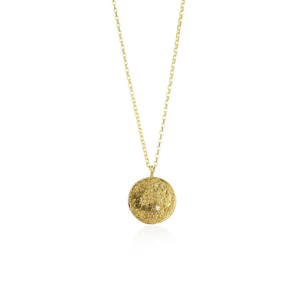 A 9k gold necklace with a textured circular pendant and a delicate flat trace chain, featuring a small diamond.