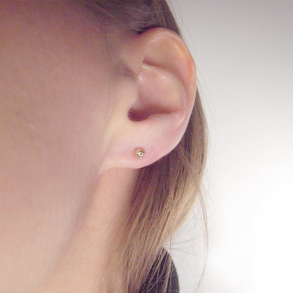 9k gold micro skull stud earrings