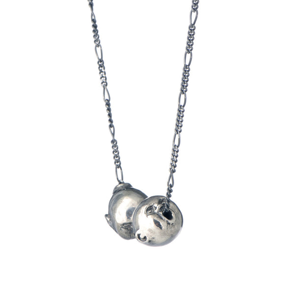 A recycled sterling silver double face pendant from 'The Secret Garden' collection with a figaro chain go go through the balls